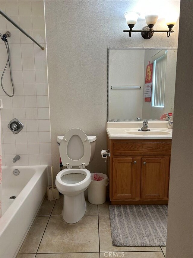 full bath featuring shower / washtub combination, toilet, vanity, and tile patterned floors