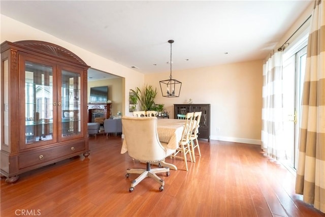 dining area featuring baseboards, visible vents, and light wood finished floors