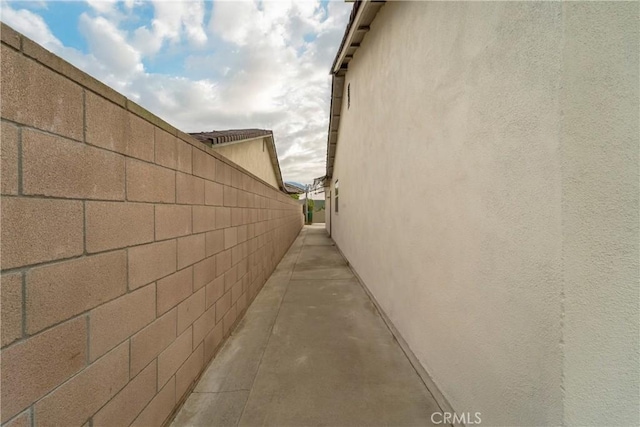 view of property exterior featuring fence and stucco siding