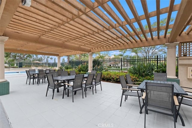 view of patio featuring a pergola, a community pool, outdoor dining space, and fence