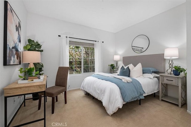 bedroom featuring light colored carpet and baseboards