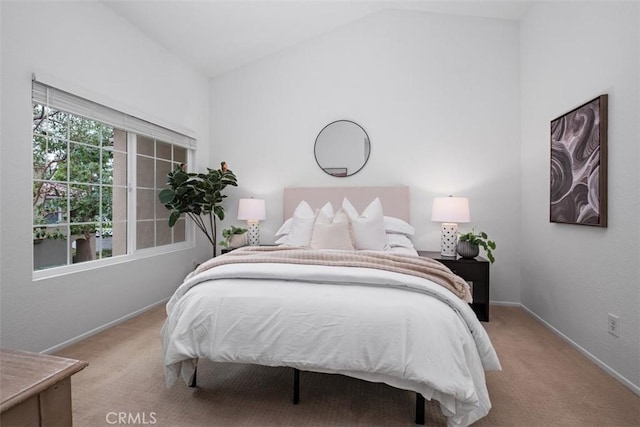 bedroom with carpet flooring, lofted ceiling, and baseboards