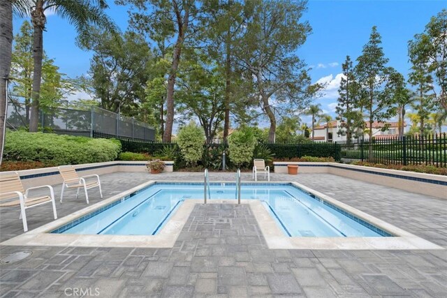 view of pool with fence and a patio area