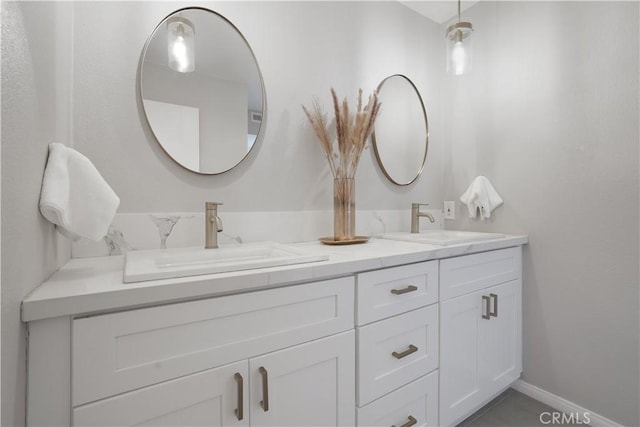 33601 Via Corvalian Unit 4, Dana Point, CA 92629 - bathroom with double vanity and baseboards