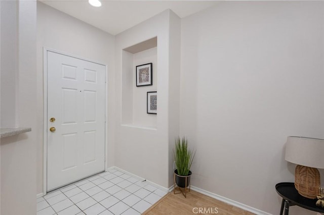 foyer featuring baseboards