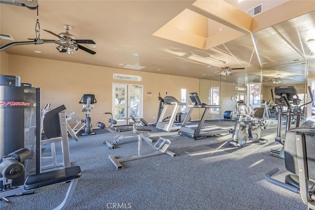gym with baseboards, visible vents, and ceiling fan