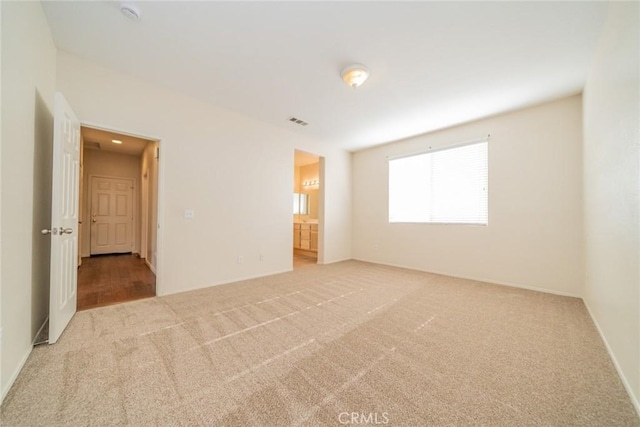carpeted empty room with baseboards and visible vents