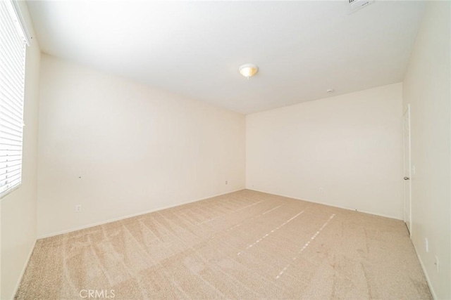 empty room with a wealth of natural light and light colored carpet