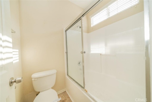 full bathroom featuring combined bath / shower with glass door and toilet