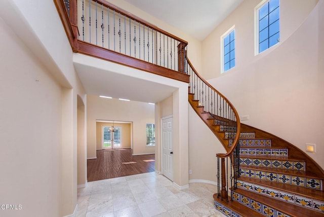 5018 Via Andrea, Newbury Park, CA 91320 - stairs featuring baseboards, tile patterned floors, a high ceiling, and a notable chandelier