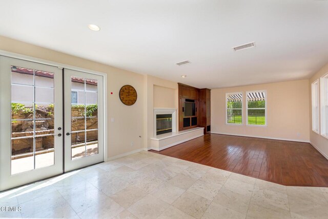 5018 Via Andrea, Newbury Park, CA 91320 - unfurnished living room featuring a glass covered fireplace, french doors, recessed lighting, baseboards, and visible vents
