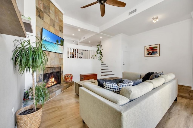 6755 Caminito Del Greco, San Diego, CA 92120 - living area featuring a tiled fireplace, light wood-type flooring, a ceiling fan, ornamental molding, and recessed lighting