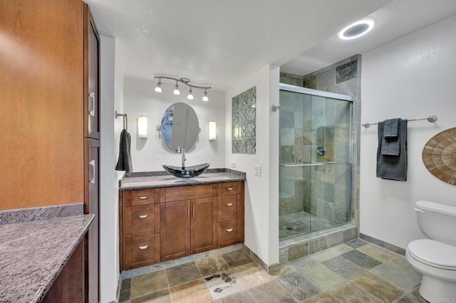 6755 Caminito Del Greco, San Diego, CA 92120 - bathroom with toilet, a shower stall, stone finish flooring, vanity, and a textured ceiling