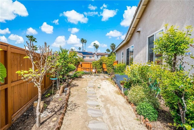 view of yard with a fenced backyard, a patio, and a residential view