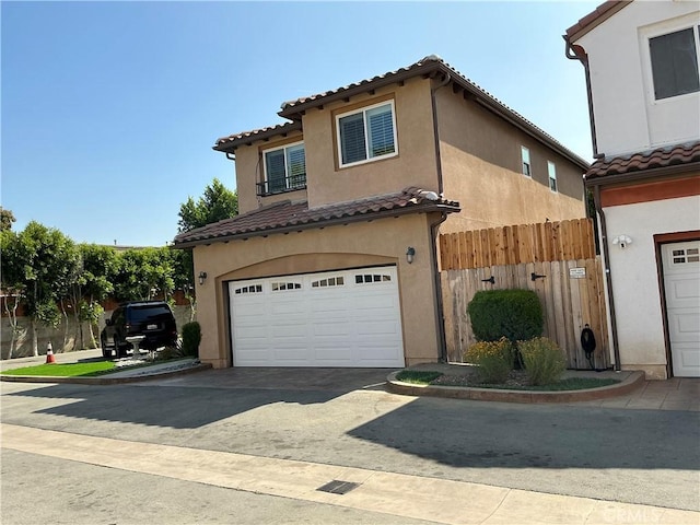 8621 Noble Ave Unit 4, North Hills, CA 91343 - view of front facade featuring a tile roof, a garage, stucco siding, and fence