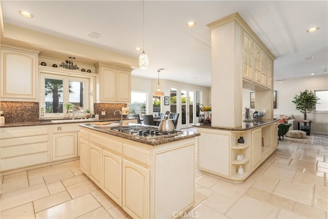 12 Santa Barbara Pl, Laguna Niguel, CA 92677 - kitchen featuring dark stone countertops, stainless steel gas cooktop, cream cabinets, decorative backsplash, and a sink