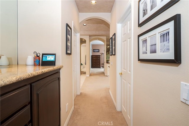 12 Santa Barbara Pl, Laguna Niguel, CA 92677 - hallway featuring baseboards, recessed lighting, arched walkways, and light carpet