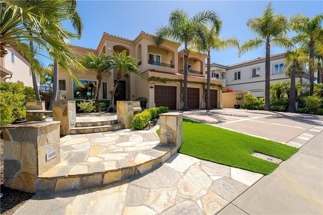 12 Santa Barbara Pl, Laguna Niguel, CA 92677 - mediterranean / spanish house with a garage, a balcony, driveway, a tiled roof, and stucco siding