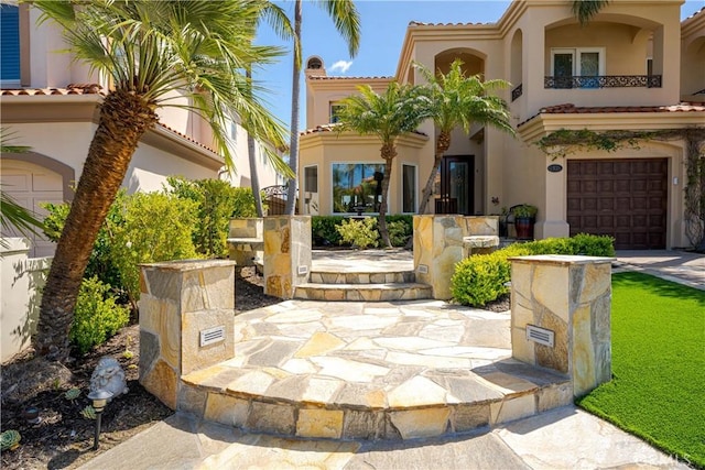 12 Santa Barbara Pl, Laguna Niguel, CA 92677 - property entrance with stucco siding, an attached garage, and a tile roof