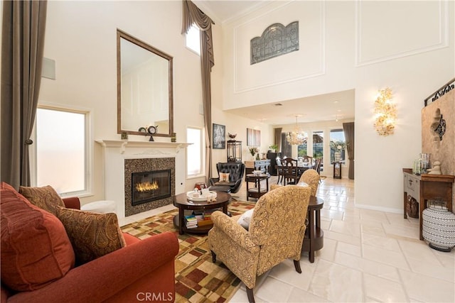 12 Santa Barbara Pl, Laguna Niguel, CA 92677 - living area with a glass covered fireplace, a notable chandelier, and a high ceiling