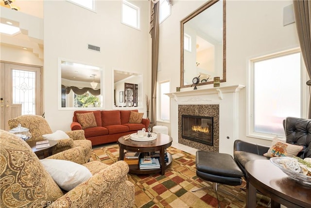 12 Santa Barbara Pl, Laguna Niguel, CA 92677 - living area featuring a high ceiling, visible vents, and a glass covered fireplace