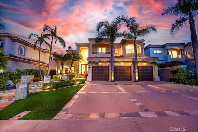 12 Santa Barbara Pl, Laguna Niguel, CA 92677 - mediterranean / spanish home featuring concrete driveway, a balcony, a tiled roof, stucco siding, and a garage