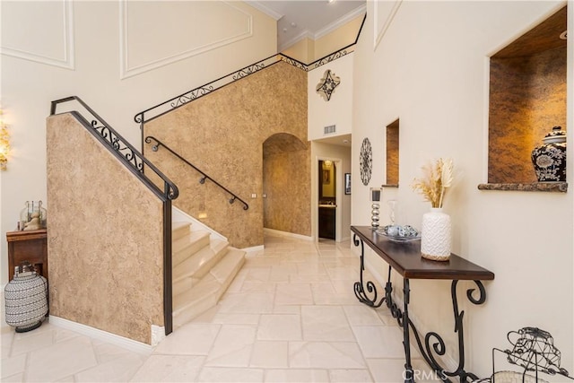 12 Santa Barbara Pl, Laguna Niguel, CA 92677 - entrance foyer with stairway, visible vents, arched walkways, ornamental molding, and a towering ceiling