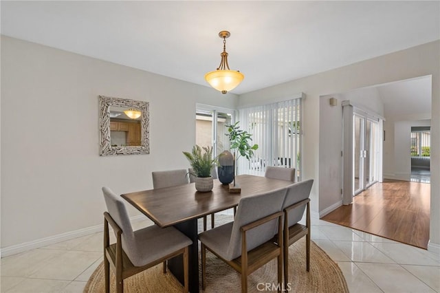 dining area with baseboards and light tile patterned flooring