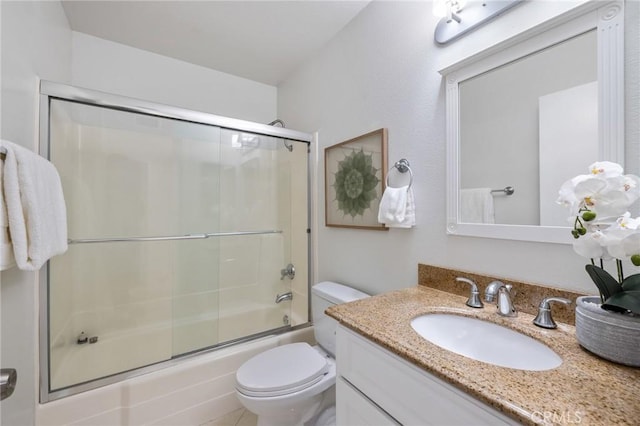 bathroom with shower / bath combination with glass door, toilet, and vanity