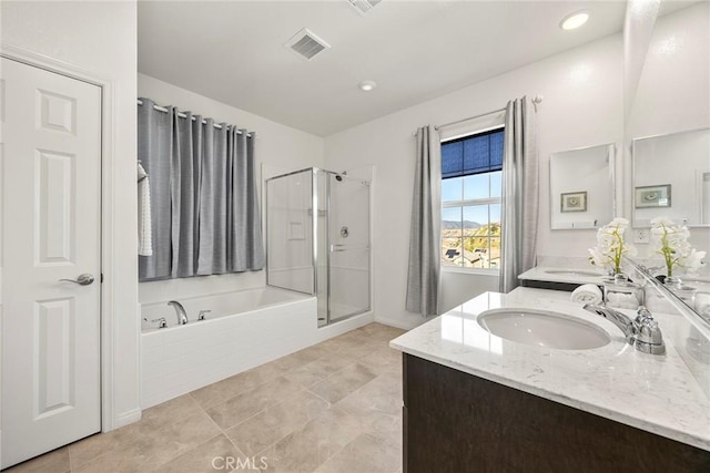 full bath featuring double vanity, a garden tub, visible vents, a stall shower, and a sink