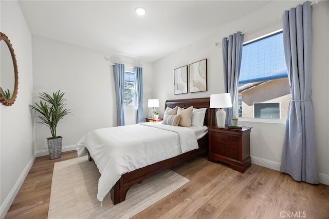 bedroom with baseboards and light wood-style flooring