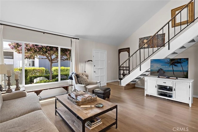 133 Morristown Ln, Costa Mesa, CA 92626 - living area featuring stairway, vaulted ceiling, wood finished floors, and baseboards