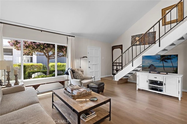 133 Morristown Ln, Costa Mesa, CA 92626 - living room featuring stairway, vaulted ceiling, and wood finished floors