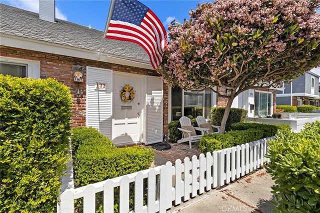 133 Morristown Ln, Costa Mesa, CA 92626 - view of exterior entry with brick siding and a chimney