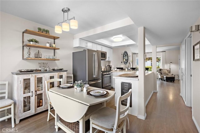 133 Morristown Ln, Costa Mesa, CA 92626 - dining space with wood finished floors, baseboards, and a raised ceiling