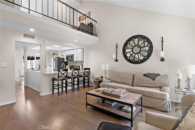 133 Morristown Ln, Costa Mesa, CA 92626 - living area featuring wood finished floors, baseboards, a high ceiling, and recessed lighting
