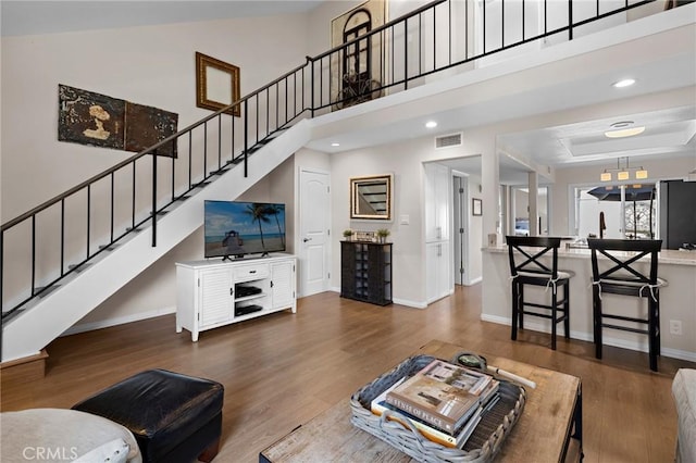 133 Morristown Ln, Costa Mesa, CA 92626 - living area with baseboards, stairway, wood finished floors, a high ceiling, and recessed lighting