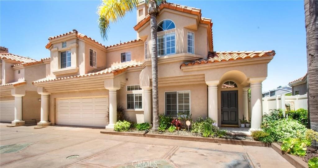 2283 La Playa Dr S, Costa Mesa, CA 92627 - mediterranean / spanish house featuring a garage, stucco siding, a tiled roof, and concrete driveway
