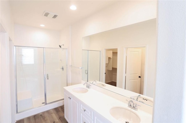 full bathroom with visible vents, a stall shower, and a sink