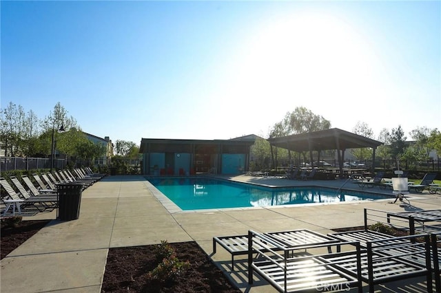 community pool featuring a gazebo, fence, and a patio area