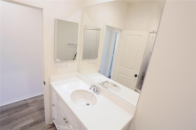 bathroom with vanity and wood finished floors