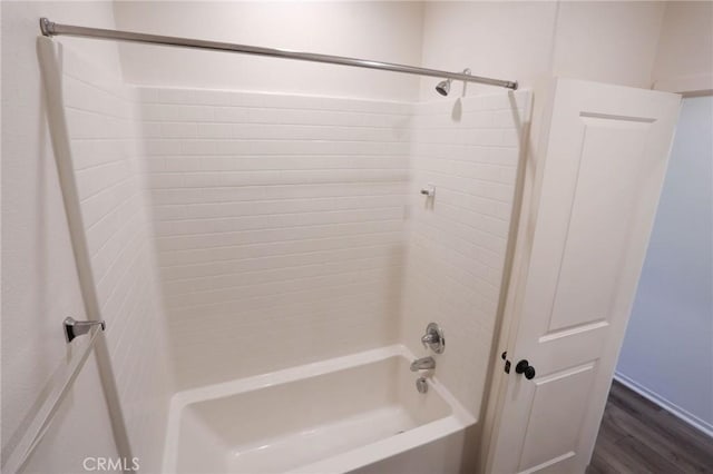bathroom featuring wood finished floors and shower / bathtub combination