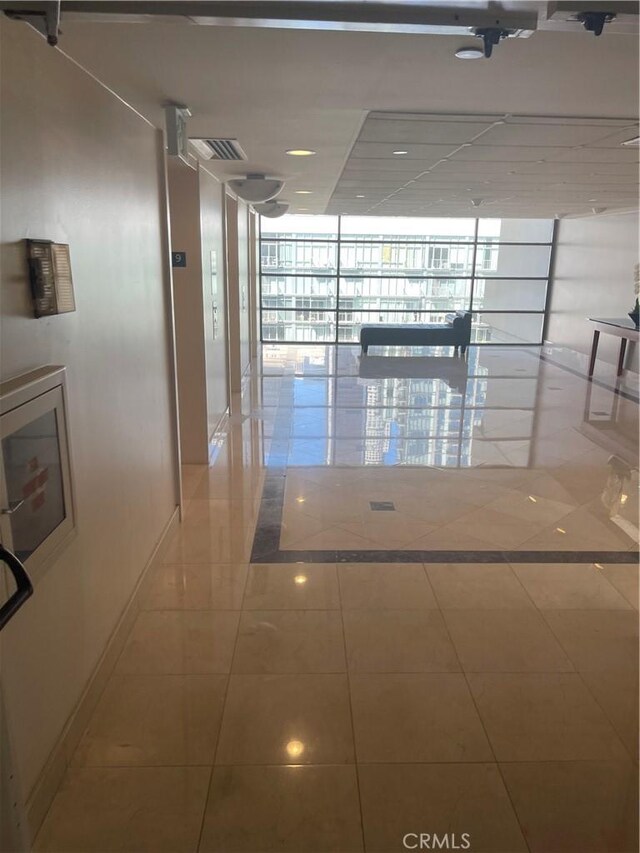 600 W 9th St Unit 902, Los Angeles, CA 90015 - hallway featuring expansive windows and baseboards