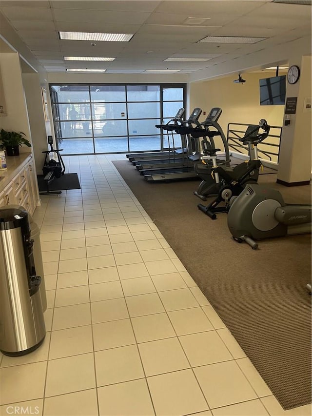600 W 9th St Unit 902, Los Angeles, CA 90015 - exercise room with a drop ceiling, light colored carpet, and light tile patterned floors
