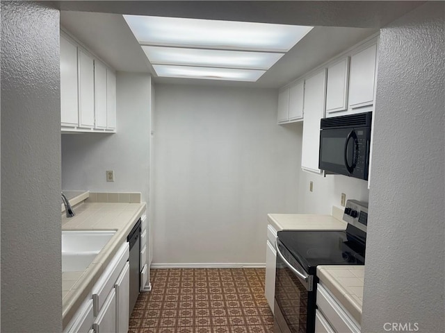 600 W 9th St Unit 902, Los Angeles, CA 90015 - kitchen featuring appliances with stainless steel finishes, tile counters, tile patterned floors, and white cabinetry