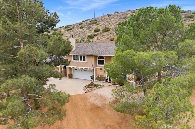33435 Hubbard Rd, Acton, CA 93510 - view of front of property with driveway, a garage, a chimney, and stucco siding