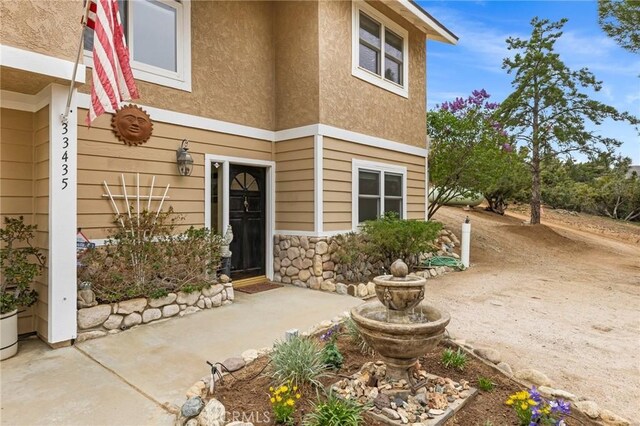 33435 Hubbard Rd, Acton, CA 93510 - property entrance featuring stucco siding and a patio
