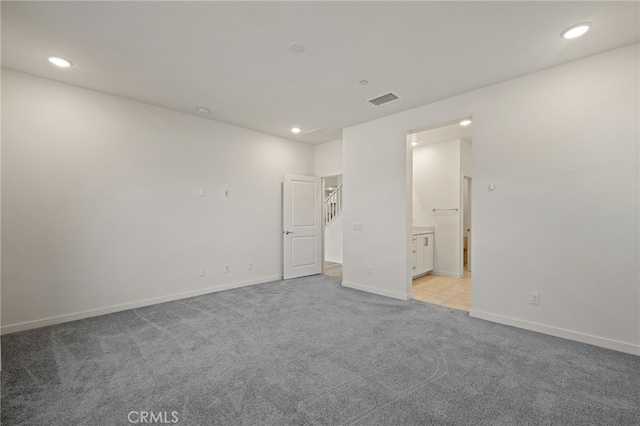 unfurnished bedroom featuring recessed lighting, visible vents, light carpet, and baseboards