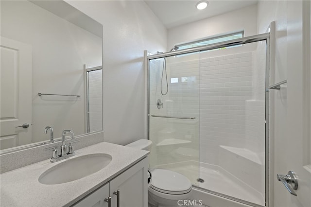 full bath featuring vanity, toilet, and a stall shower