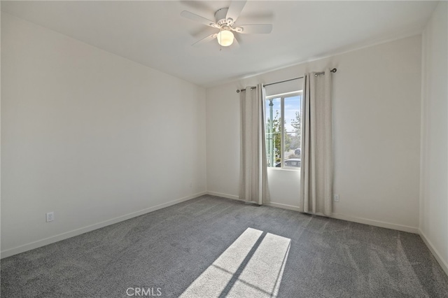 spare room with a ceiling fan, baseboards, and carpet floors